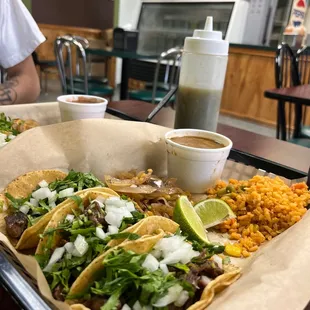 a tray of tacos and rice