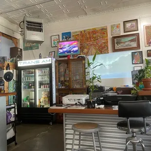 a bar with chairs and a television
