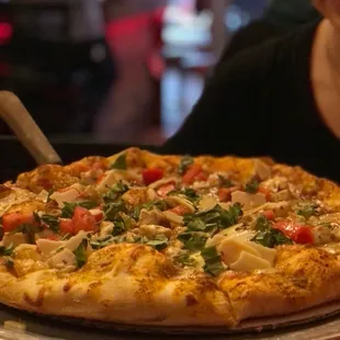 a woman holding a pizza