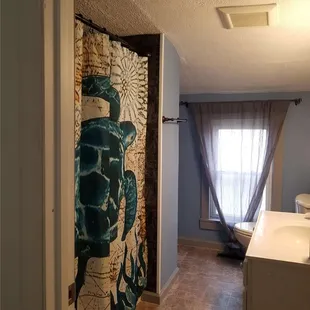 a bathroom with a shower curtain