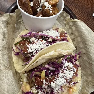 Pineapple adobo pork tacos with a side of fried potatos.