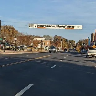 a street scene with cars and a sign