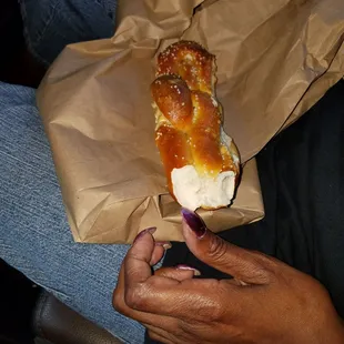 a person holding a piece of bread
