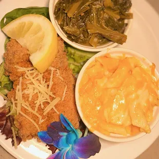 a plate of food including macaroni, cheese, and greens