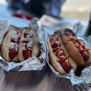 two hot dogs with mustard and ketchup
