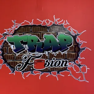 a red wall with graffiti on it