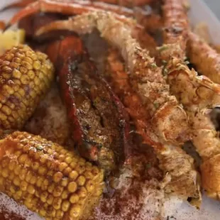 crab legs and corn on a plate