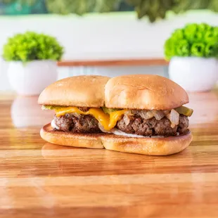 a cheeseburger on a wooden table