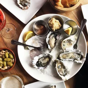 Oysters, olives, almonds, gaufrettes, drinks