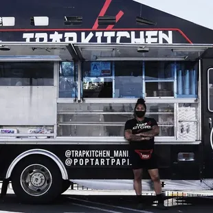 a man standing in front of a food truck