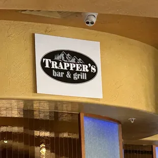 a sign for trapper&apos;s bar and grill