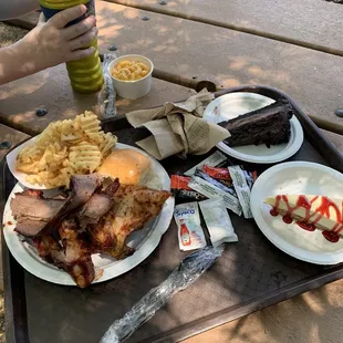 Sampler platter, chocolate cake, raspberry cheese cake and refillable drink container.
