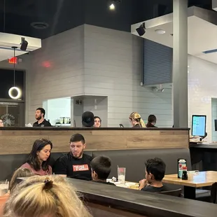 Wait staff sitting at table while customer wait for a fork.