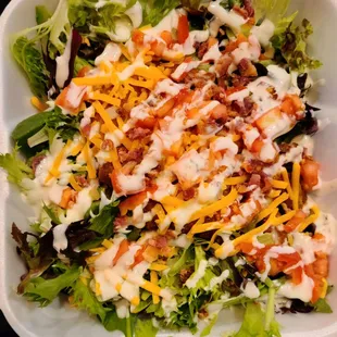 a salad in a styrofoam container