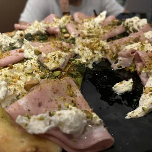 My wife had this pizza and I think it was Mortadella. She loved it and it was delicious!