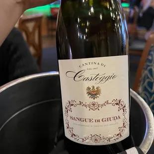 a person holding a bottle of wine