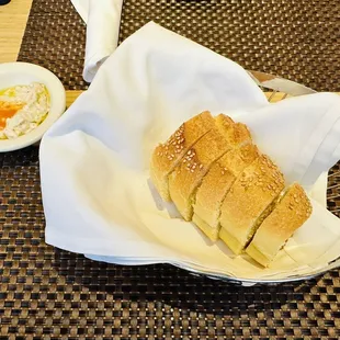 a basket of bread and a bowl of butter