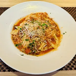 a pasta dish on a place mat