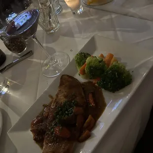 The famous chef Thomas enjoyed a branzini wrapped in sliced potatoes with a special sauce, a culinary masterpiece. .