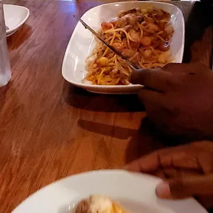 a plate of pasta and meat