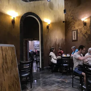 people sitting at tables in a restaurant