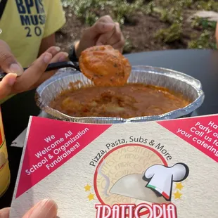 a person holding a plate of food