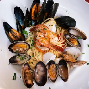 a plate of pasta with shrimp and clams