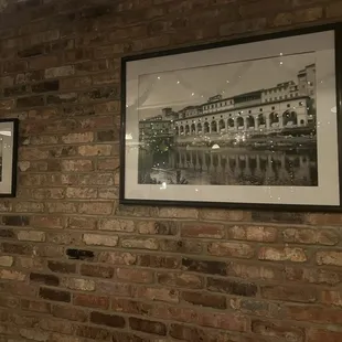 a brick wall with a picture on it