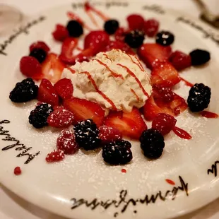 a plate of berries and ice cream
