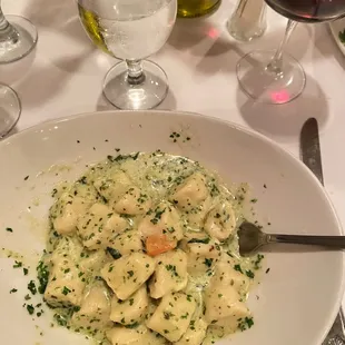 a plate of pasta and wine