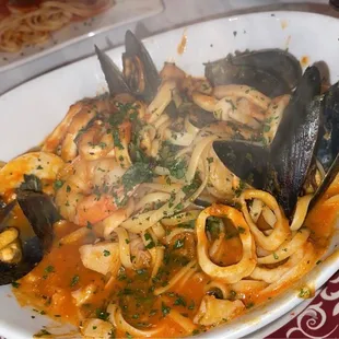 a plate of pasta with musselling and clams