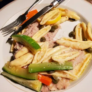 Veal piccata dinner with pasta, fresh zucchini, carrots.