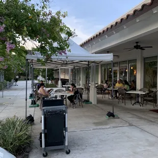a patio with tables and umbrellas