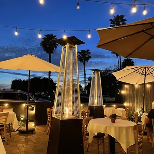 a patio with tables and umbrellas