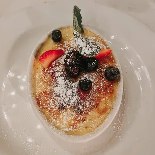 a dessert with berries and powdered sugar