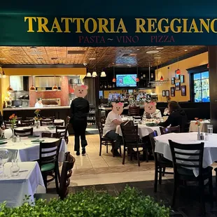 people sitting at tables in a restaurant