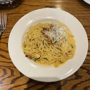a plate of pasta on a wooden table