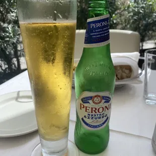 a bottle of peroni beer and a glass of beer