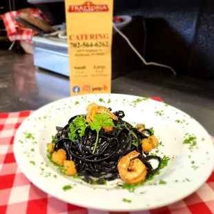 a plate of pasta with shrimp