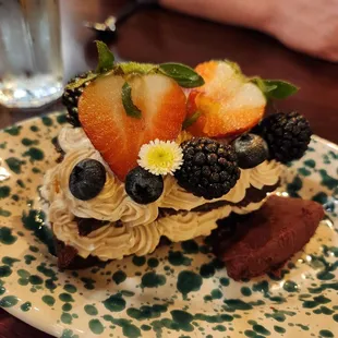 Special dessert: chocolate cake with espresso mouse, ganache, and fresh fruit,