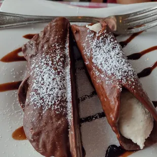 a chocolate dessert with ice cream and chocolate sauce