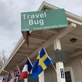 flags hanging from the side of a building
