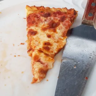 a slice of pizza on a plate with a knife