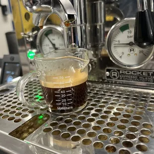 a cup of coffee on a coffee machine
