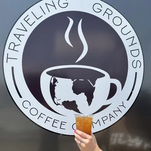 a hand holding a cup of coffee