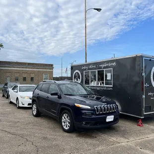 a jeep parked in front of a coffee trailer