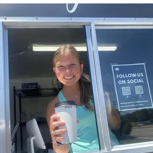 a woman holding a cup of coffee