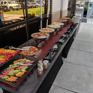 a long table with a variety of food on it