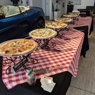 a variety of pizzas on a table