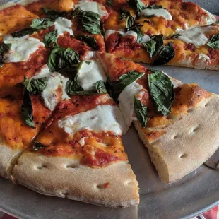a pizza with spinach and cheese